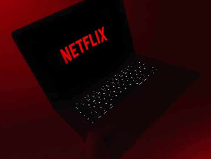 black laptop computer on red table